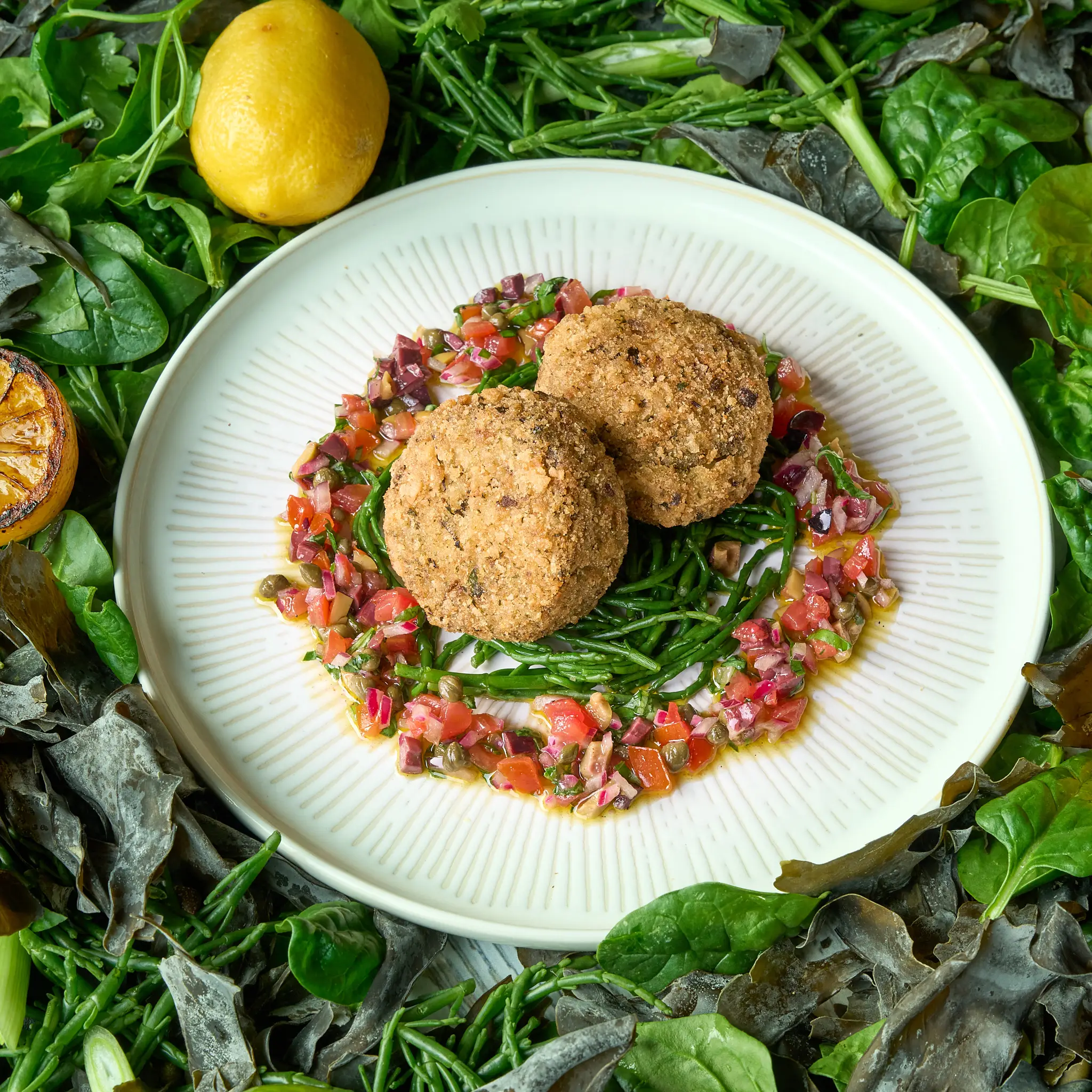 Vegan seacakes served on a spinach and watercress salad