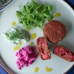 Mac 'n' beet fishcakes on a plate served with watercress