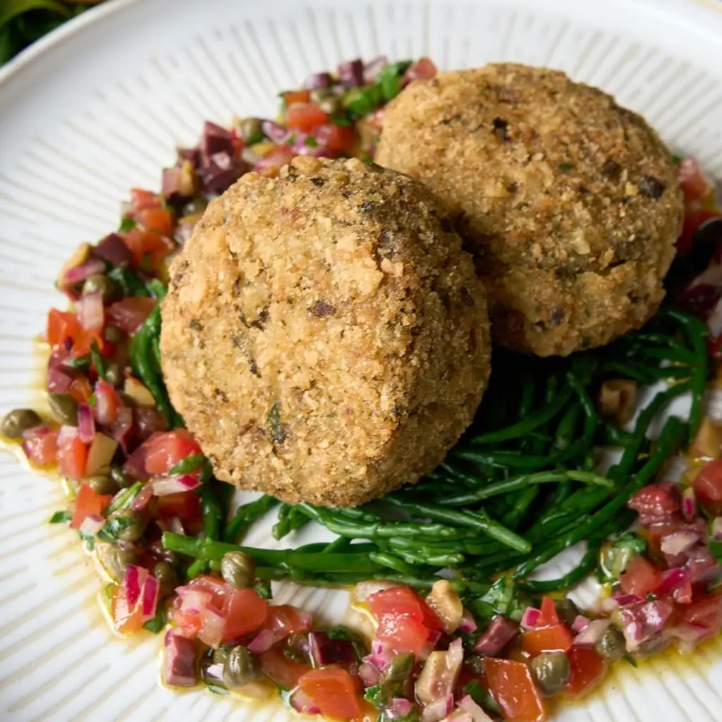 Vegan seacakes on a bed of samphire